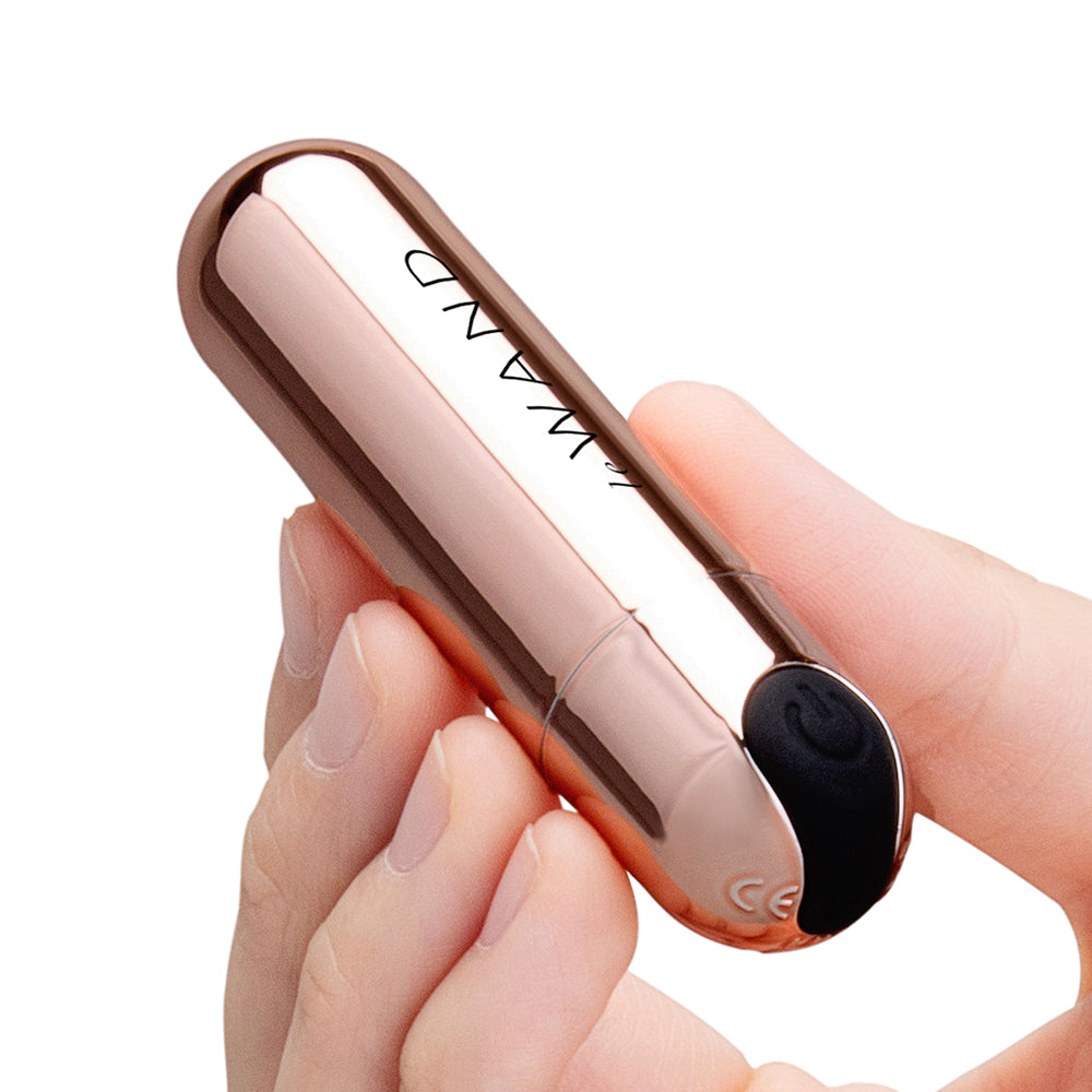 Le Wand Essentials Mini Rose Gold Bullet Vibrator held in hand showcasing its sleek design and pinpointed tip.