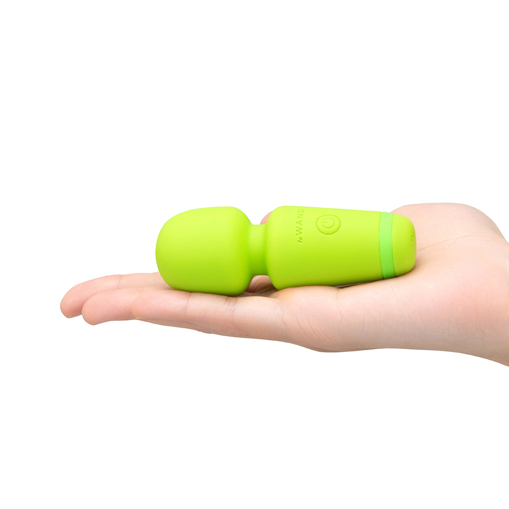 Le Wand Essentials Mini Wand Vibe Pocket-sized Vibrator held in hand for easy portability and discreet enjoyment.