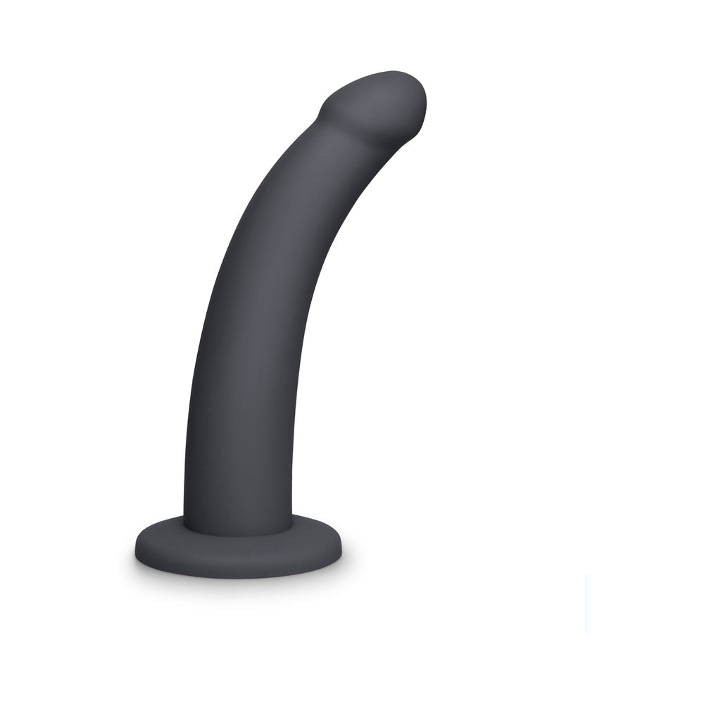 B-Vibe Essentials 7 Inch Smooth Silicone Dildo Black in a sleek, modern black finish, ideal for solo or partnered play.
