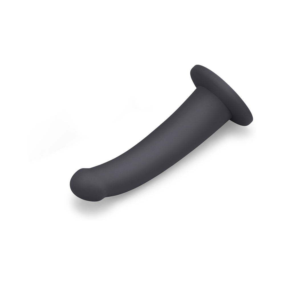 B-Vibe Essentials 7 Inch Smooth Silicone Dildo Black on a white background, showcasing its sleek and modern design.