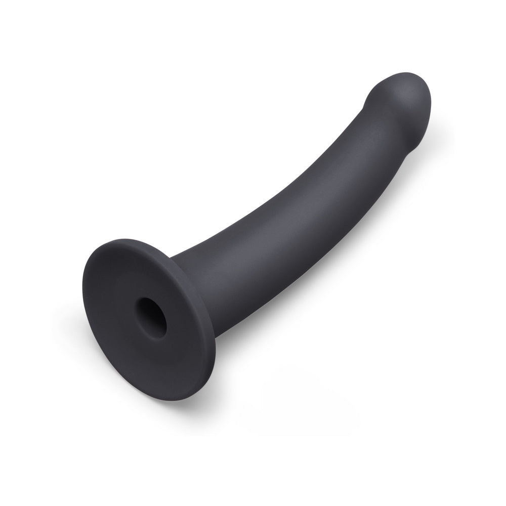 B-Vibe Essentials 7 Inch Smooth Silicone Dildo Black shown from the side on a white background.