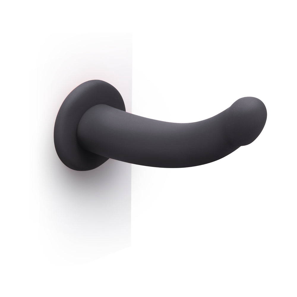 B-Vibe Essentials 7 Inch Smooth Silicone Dildo Black on a white background showcasing its sleek design.