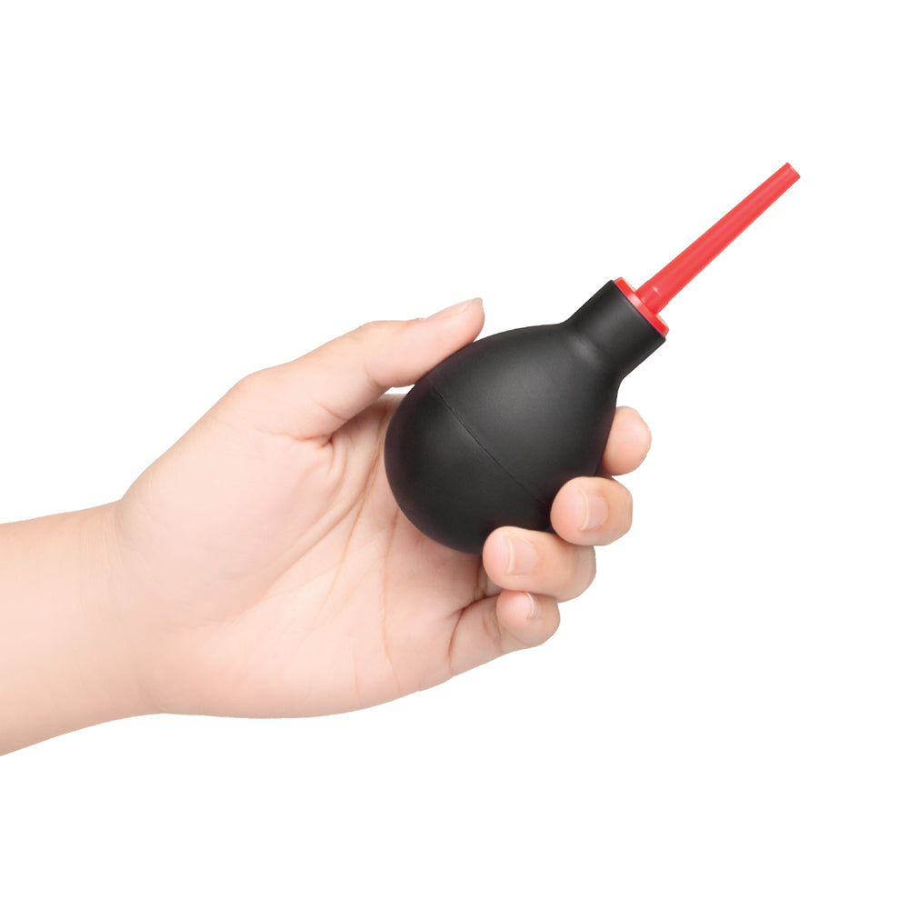 b-Vibe Essentials Mini Travel Enema Set 30 ml shown in handheld position with red attachment.