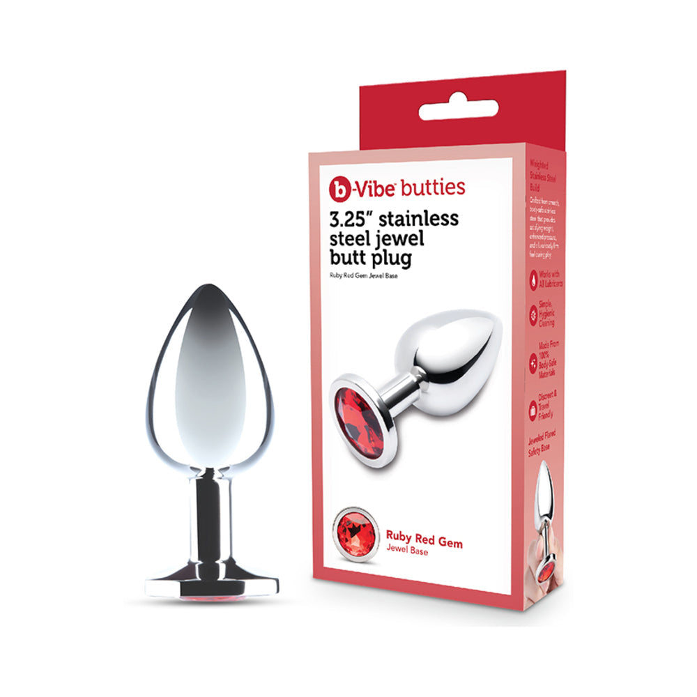 B-vibe 3.25 Inch Stainless Steel Jewel Butt Plug Red displayed next to packaging, showcasing its polished design and red jewel base.