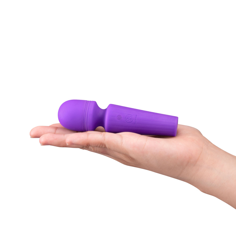 Together Glow On The Go Mini Wand Vibrator held in hand, compact and discreet design for travel.