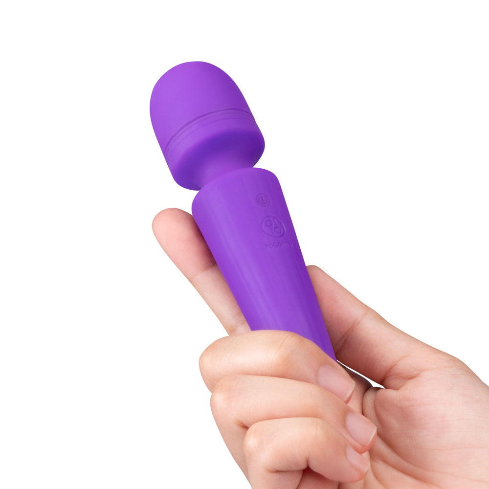 Together Glow On The Go Mini Wand Vibrator held in hand, compact and discreet for travel and pleasure.