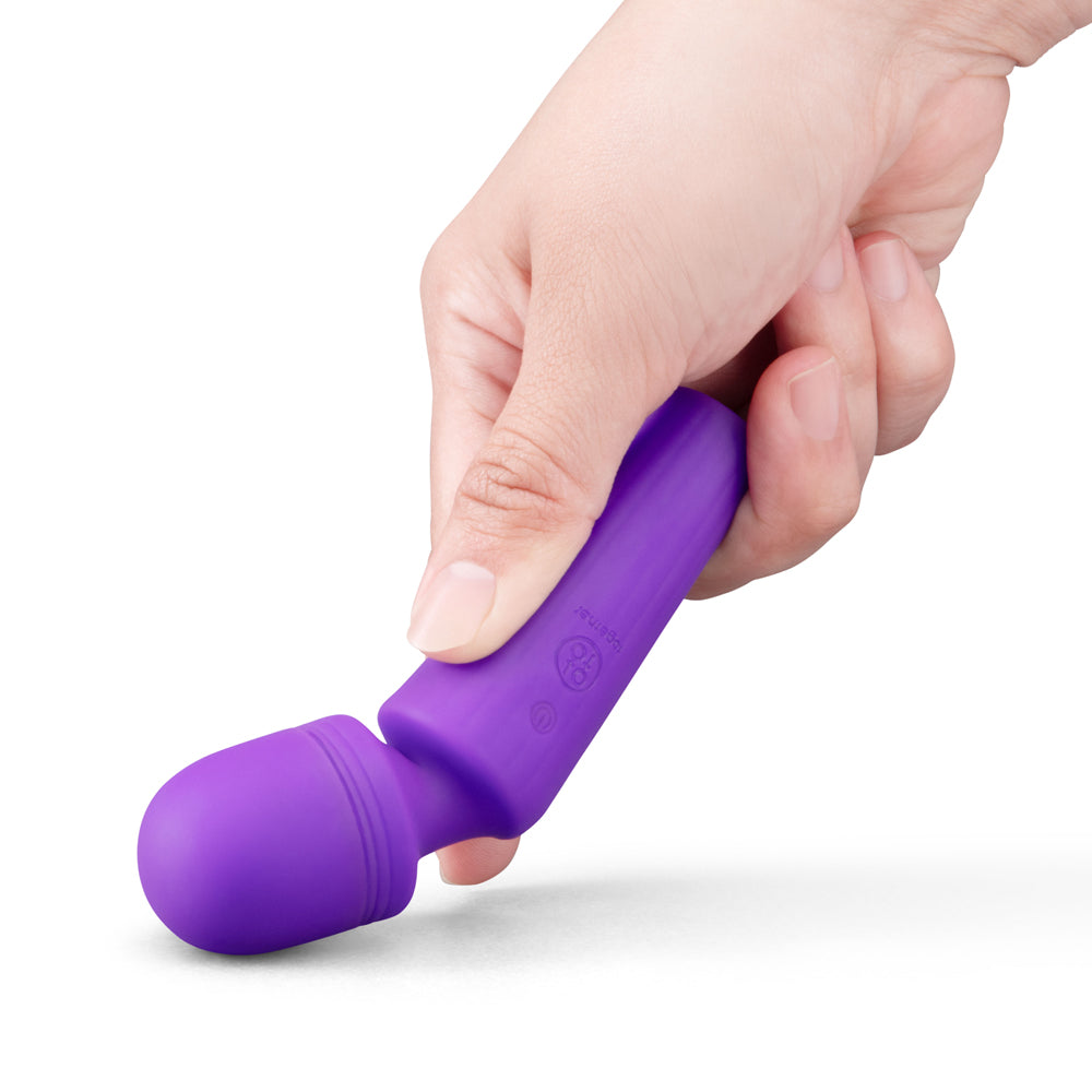 Together Glow On The Go Mini Wand Vibrator held in hand, showcasing its compact and discreet design for pleasure.