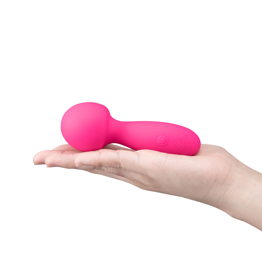 Together Spark On The Go Mini Wand Vibrator in a hand, showcasing its compact pink design for pleasure on-the-go.