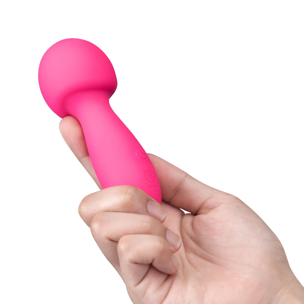 Together Spark On The Go Mini Wand Vibrator held in a hand, showcasing its compact and playful design.