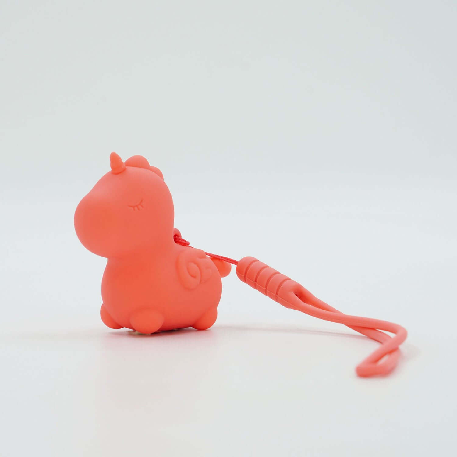 Peachy Pony Unihorn Mini Vibrator in coral color, featuring a cute unicorn design with a textured handle.