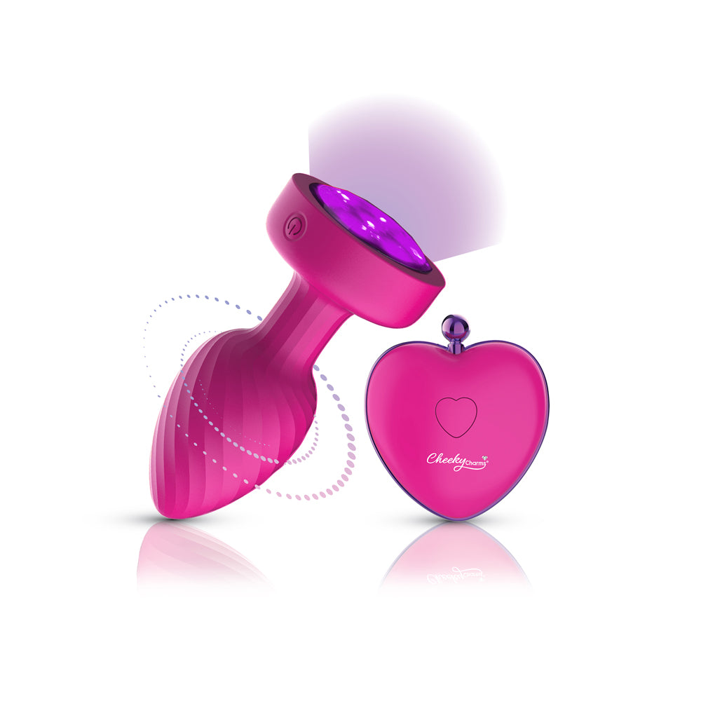 Twila Twirling Purple Gem Light Up Vibrating Plug With Heart Remote featuring a glowing jeweled base and remote control.