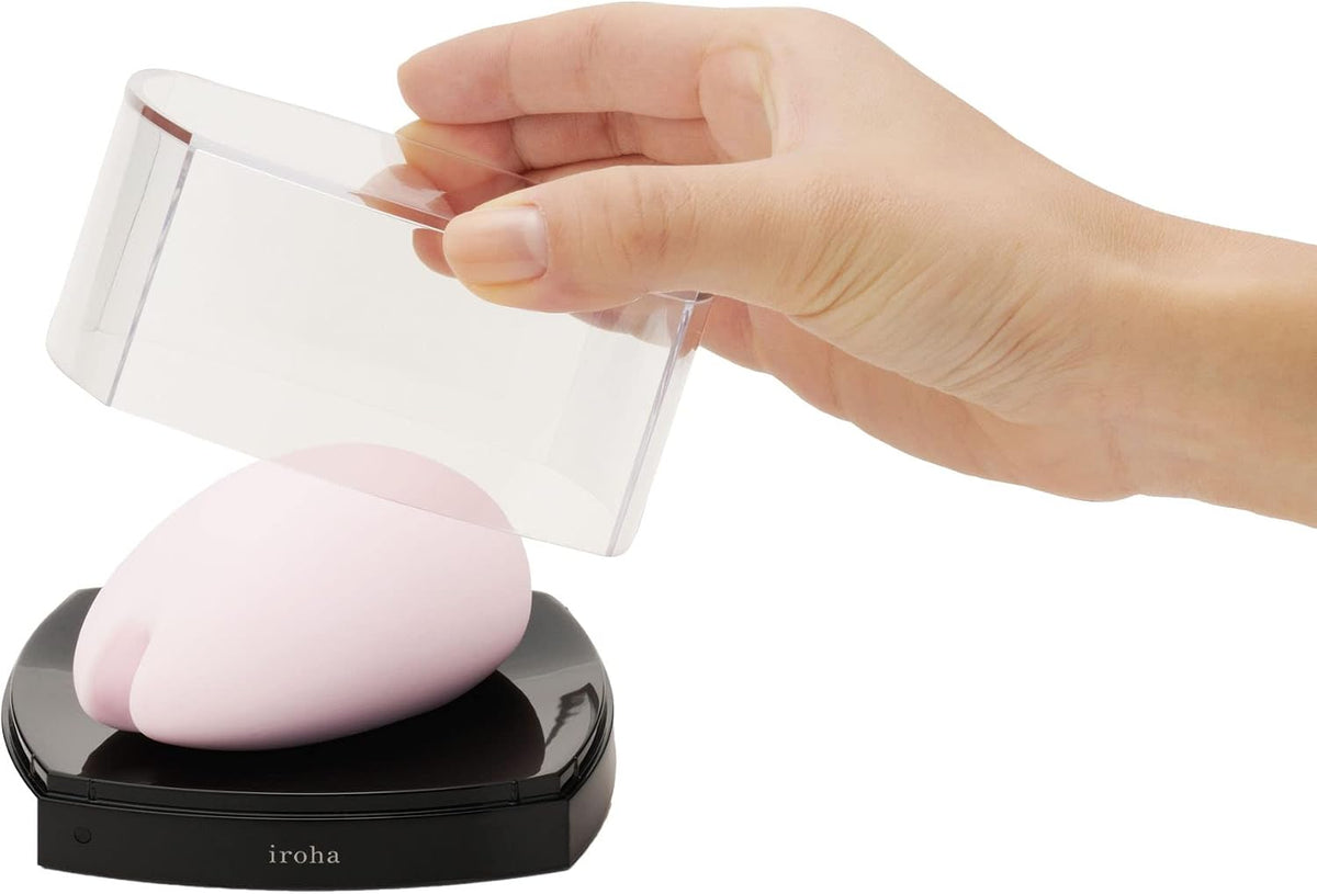 Tenga Iroha Sakura Vibrator Pink being revealed from its protective cover.