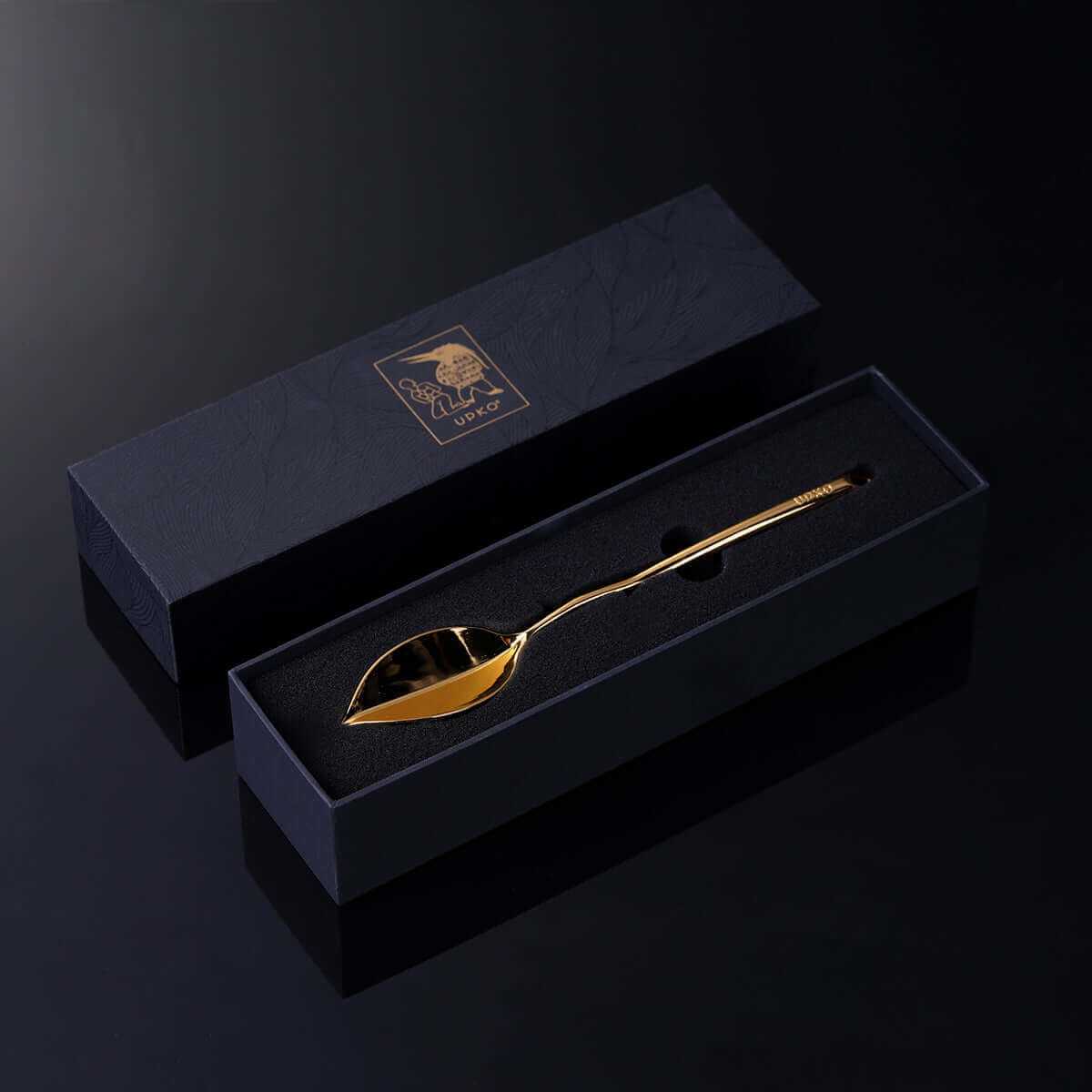 Luxurious gold spoon displayed in an elegant black packaging box, perfect for gifting and special occasions.