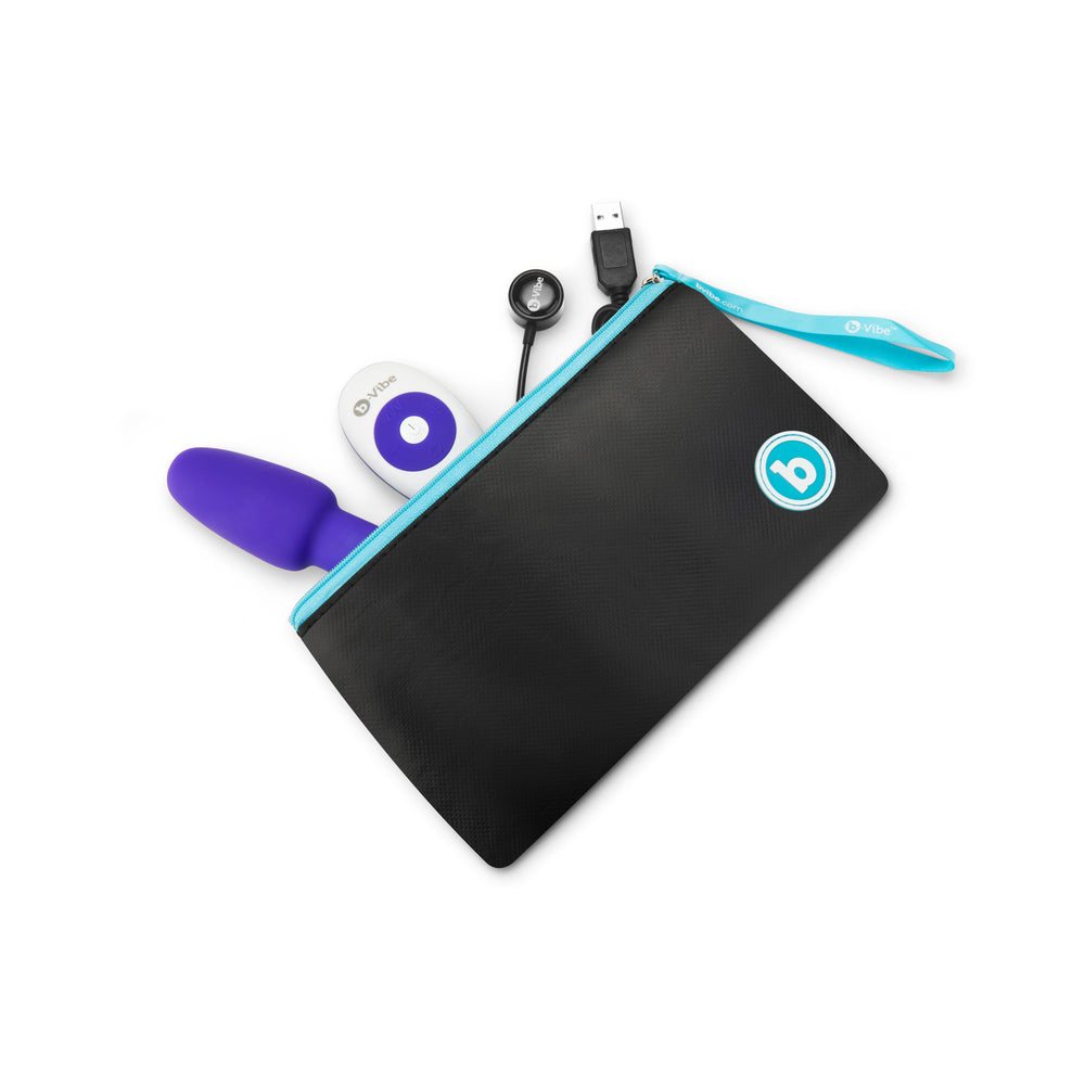 b-Vibe Rimming Petite Rotating Remote Control Plug Purple in a sleek black storage pouch with accessories.