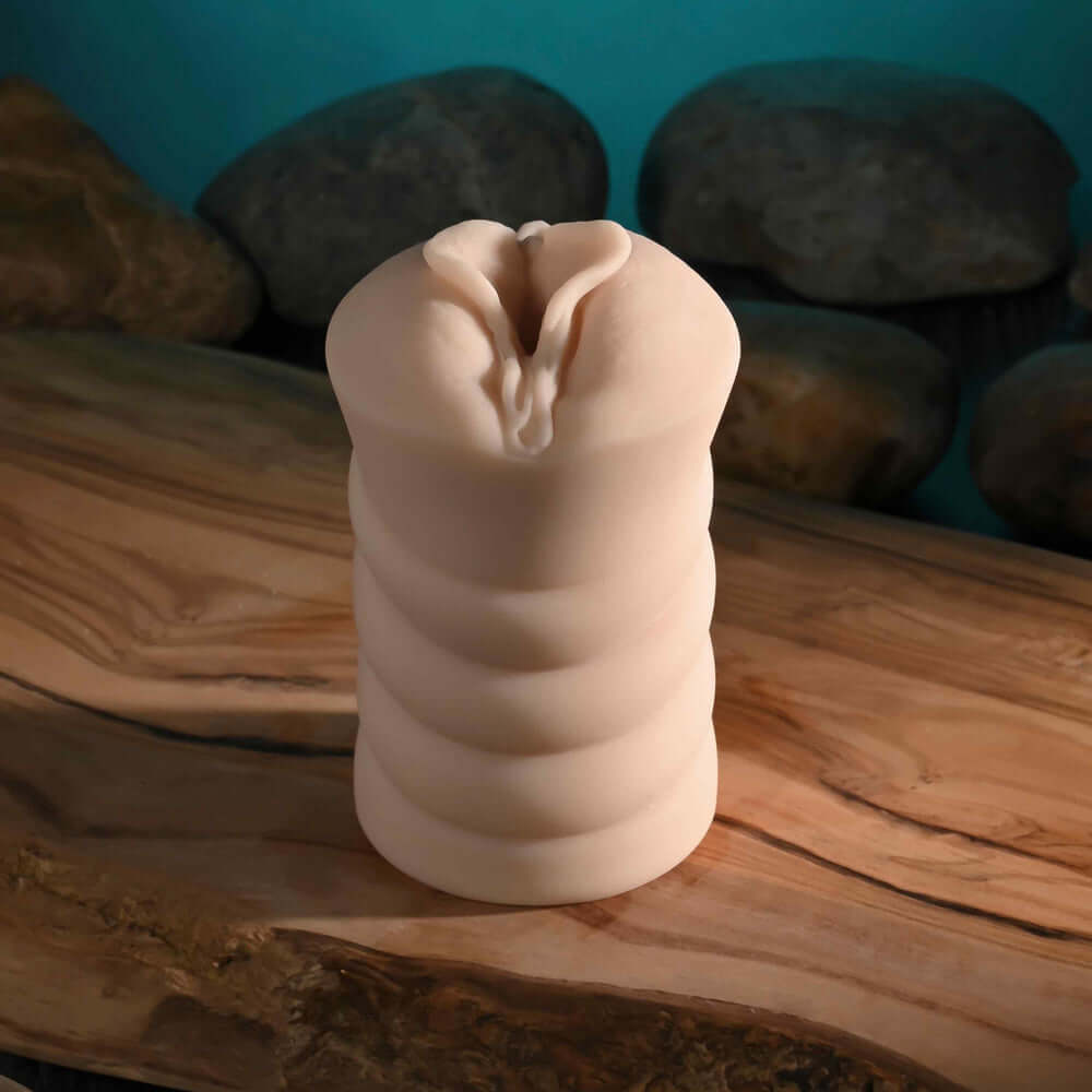 Dani Daniels Movie With Mini Vagina Stroker displayed on a wooden surface with a textured design for enhanced experience.