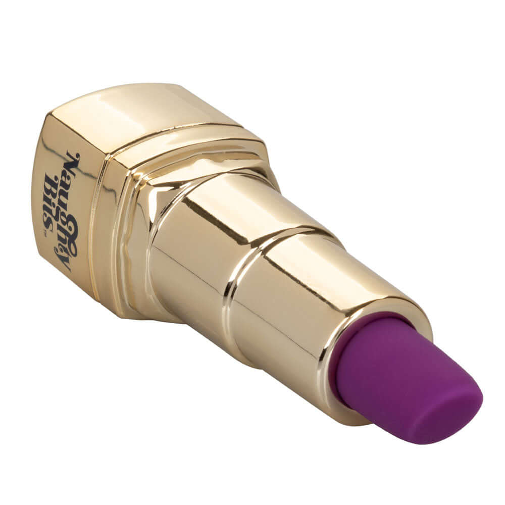 Naughty Bits Bad Bitch Lipstick Vibrator in gold casing with purple tip, designed for discreet pleasure.
