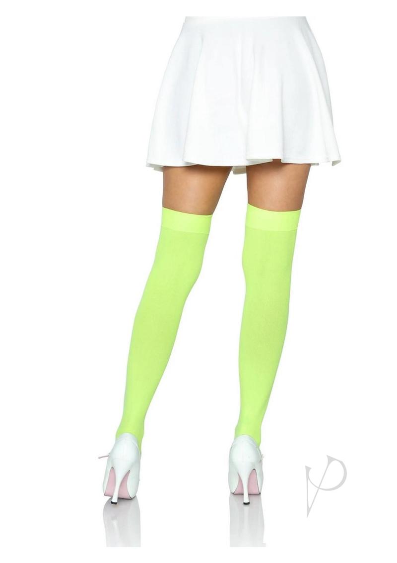 Leg Avenue Nylon Over The Knee Socks One Size Neon Green styled with a white skirt and high heels.