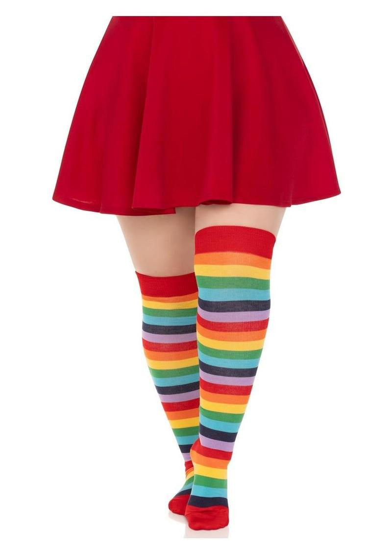 Leg Avenue Lycra Acrylic Rainbow Thigh High 1X 2X worn with a red skirt, showcasing vibrant rainbow stripes.