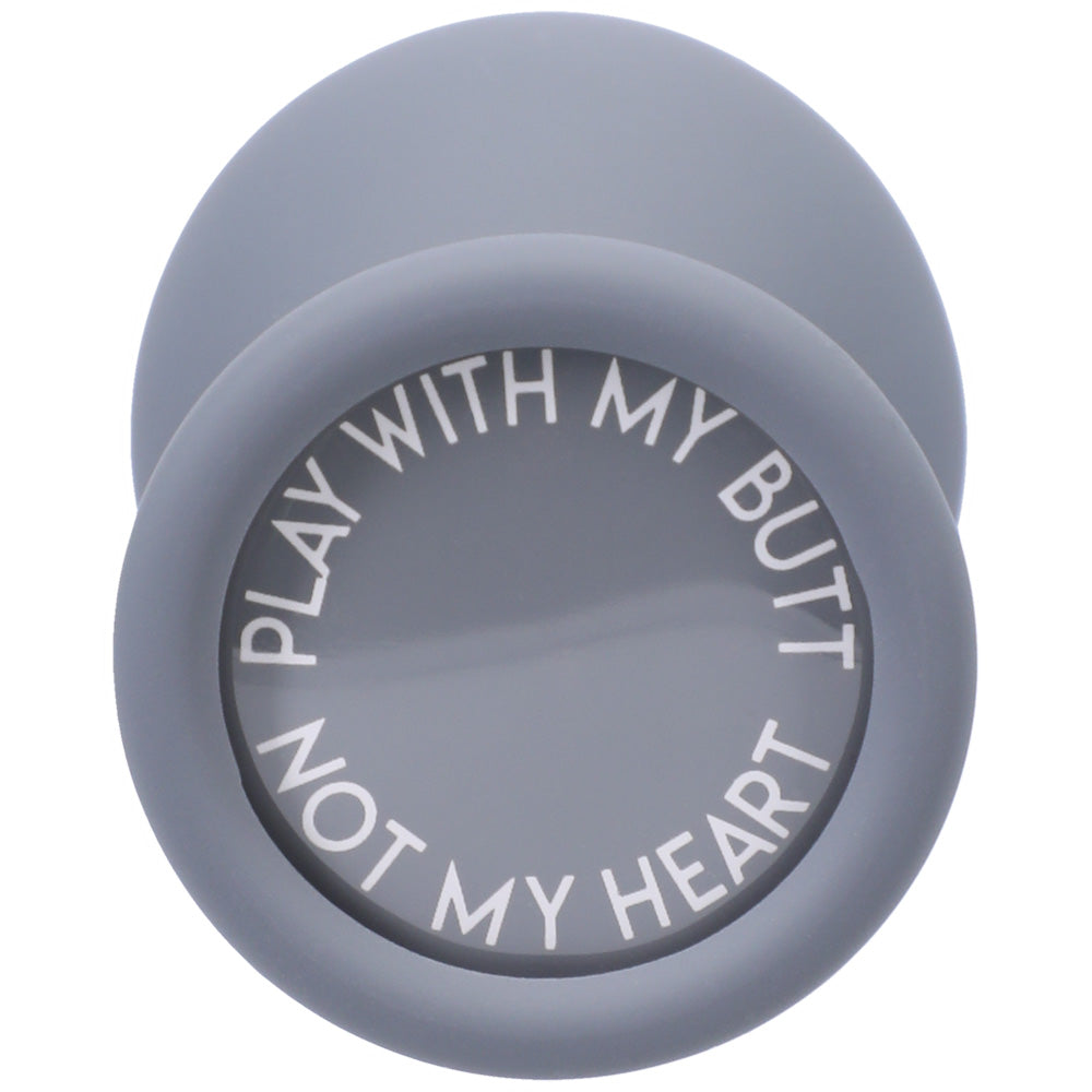 A-Play Silicone Anal Trainer Set 3 Piece Grey with spade-shaped butt plug featuring a humorous quote on its surface.