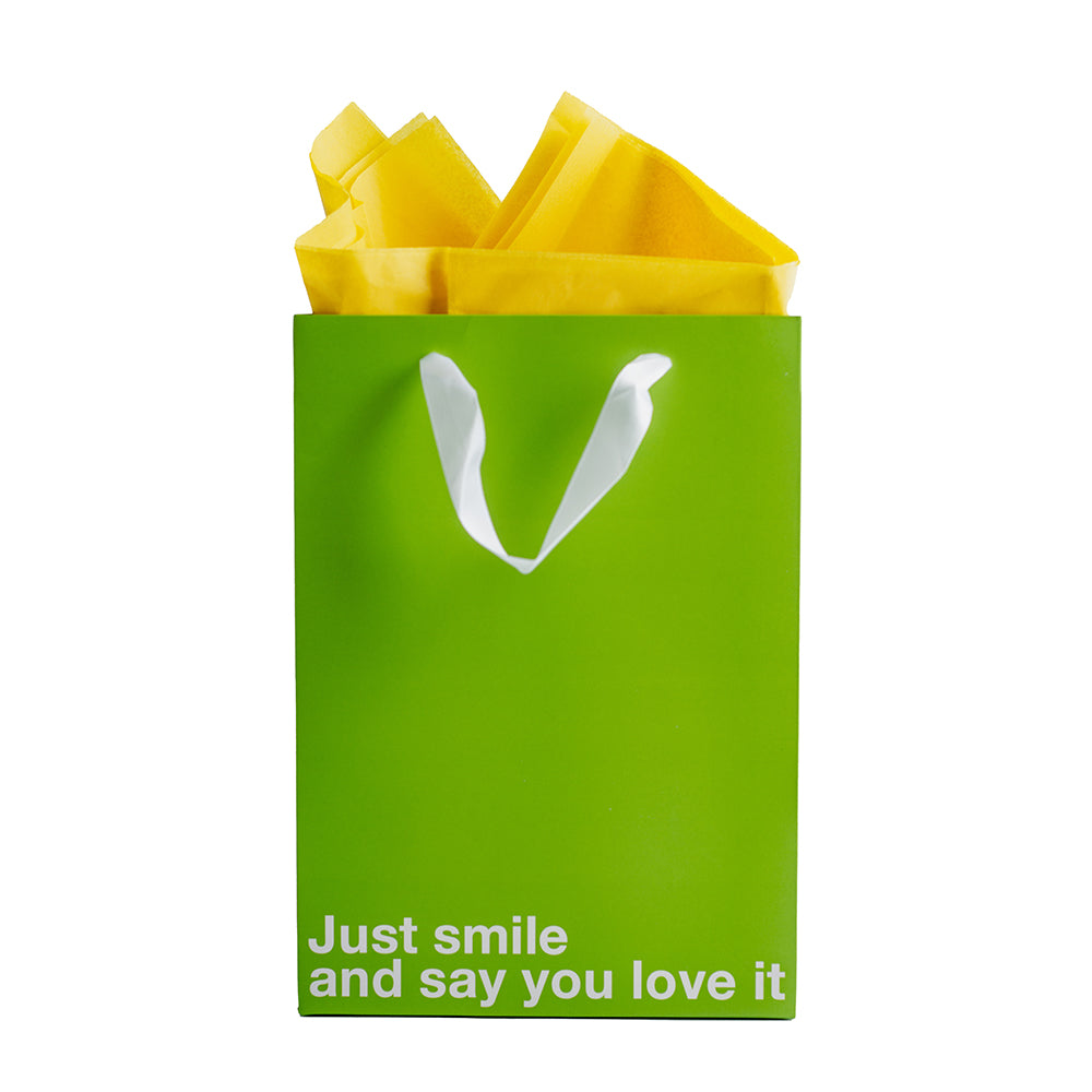 Just Smile & Say You Love It Color Gift Bag Green with yellow tissue paper for a fun gift exchange.
