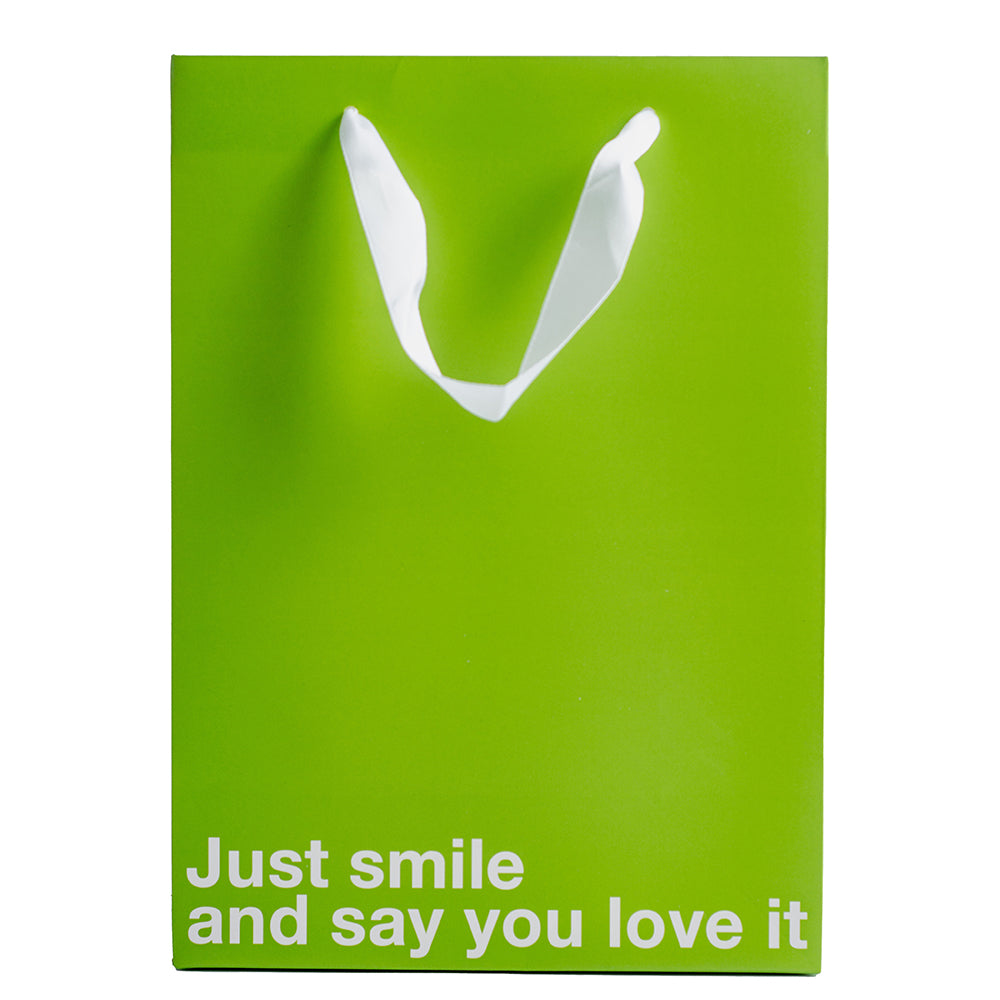 Just Smile & Say You Love It Color Gift Bag Green featuring a playful sarcastic message for gift giving.
