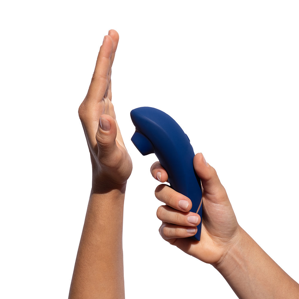 Womanizer Premium 2 Pleasure Air Clitoral Stimulator Blueberry held near a hand, showcasing its elegant design.