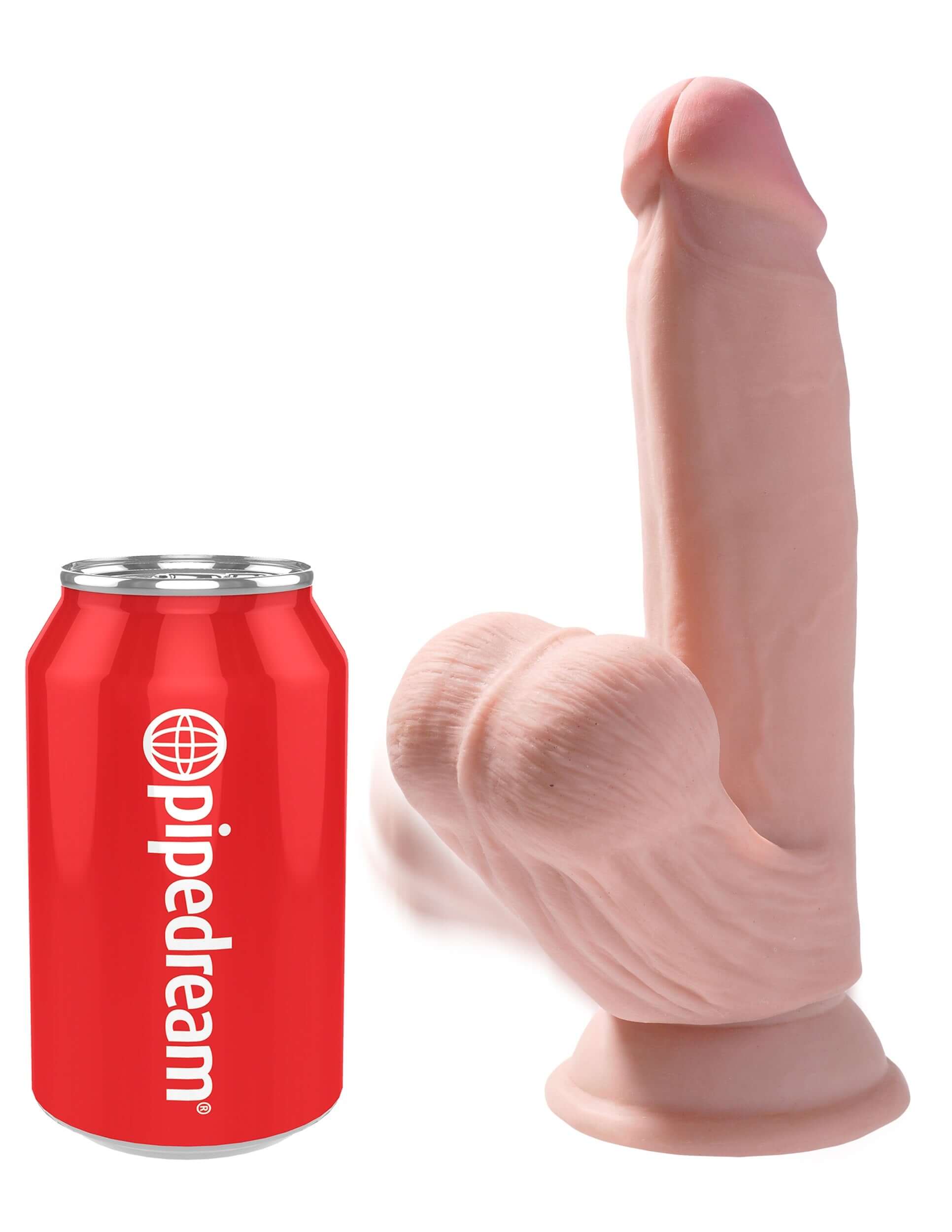 7 Inch Triple Density Cock With Swinging Balls Light next to a Pipedream soda can for size comparison.