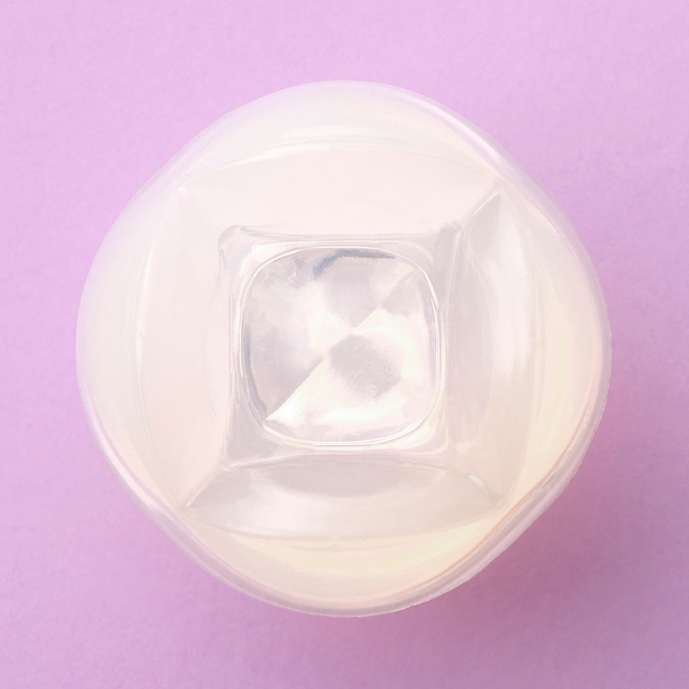 Iroha Petit Lily Disposable Clitoral Stimulator Clear top view on a purple background, showcasing its unique shape and design.