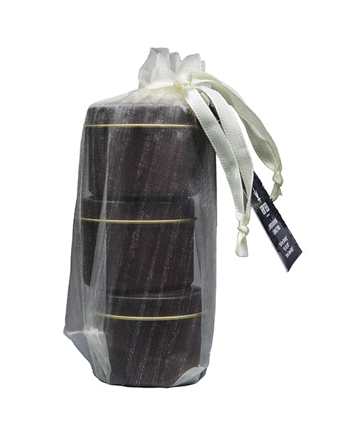 Earthly Body 2026 Holiday Massage Candle Trio Gift Set wrapped in a sheer bag with ribbon and tag.