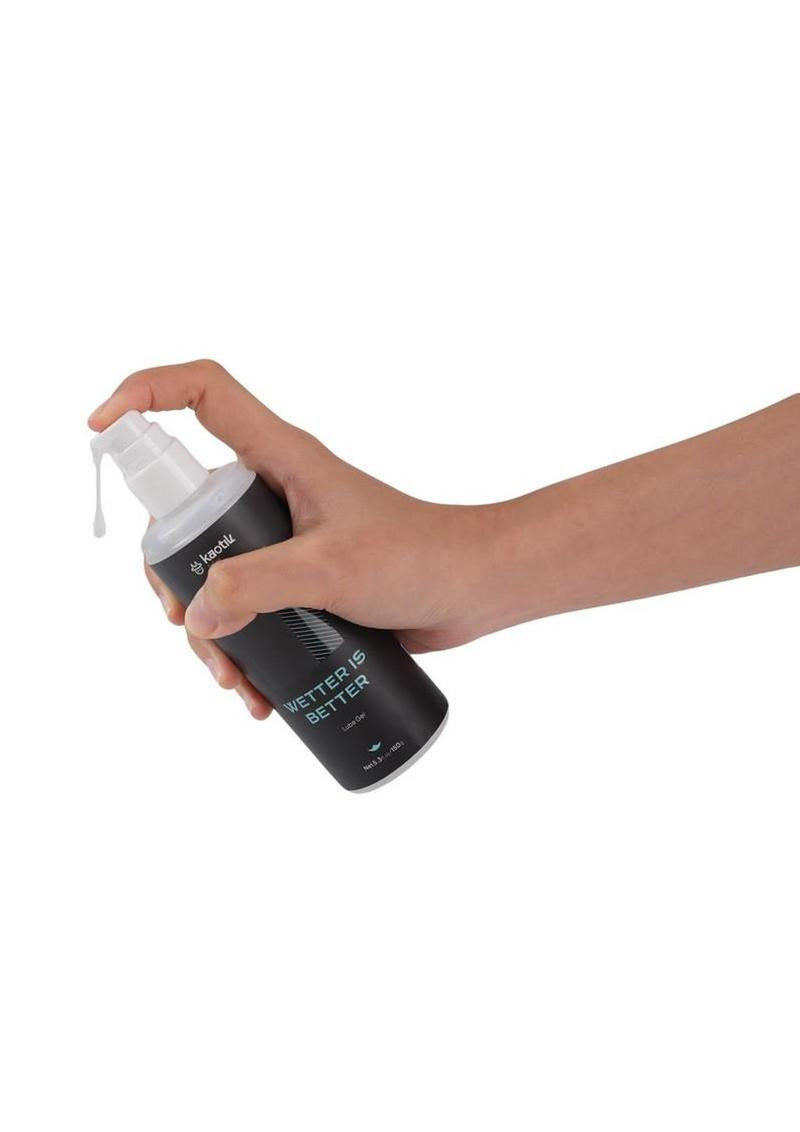 Hand holding Kaotik Labs Wetter is Better Lubricant Gel 5.3 Oz bottle with dispenser.