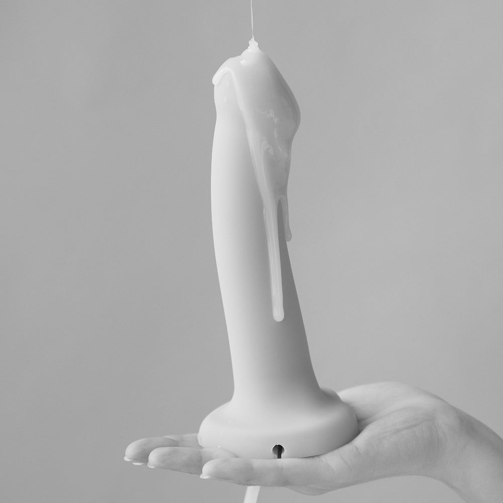 Strap-On-Me Small Silicone Squirting Cum Dildo Vanilla held in hand with squirt feature visible.
