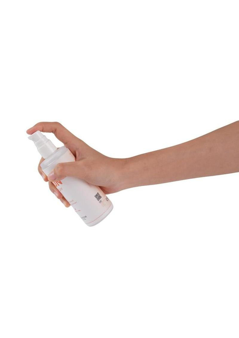 Svakom Moisturizing & Warming Water Based Lubricant 5.3 Oz being dispensed from a spray bottle.