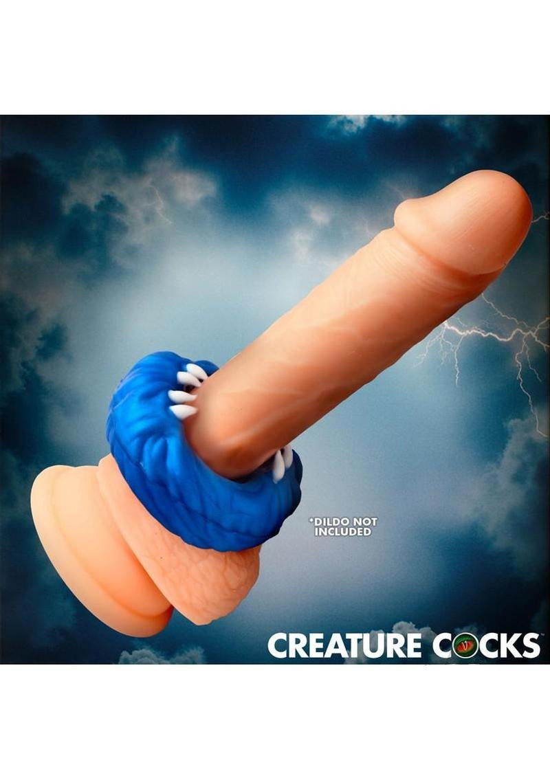 Creature Cocks Venom Loop Silicone Cock Ring Blue on a dildo against a stormy background, showcasing its unique design.