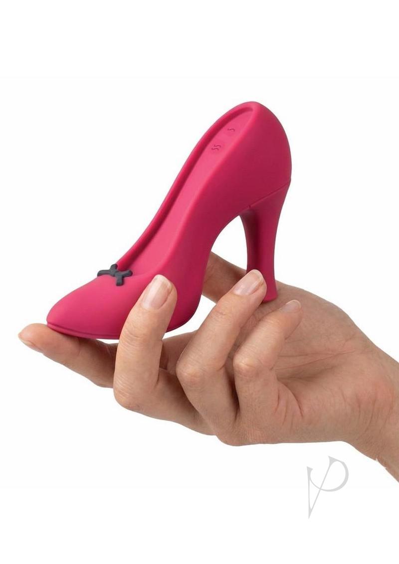 Power Pump Dual Motor Rechargeable Silicone Vibrator Red held in hand, designed like a stylish high heel shoe.