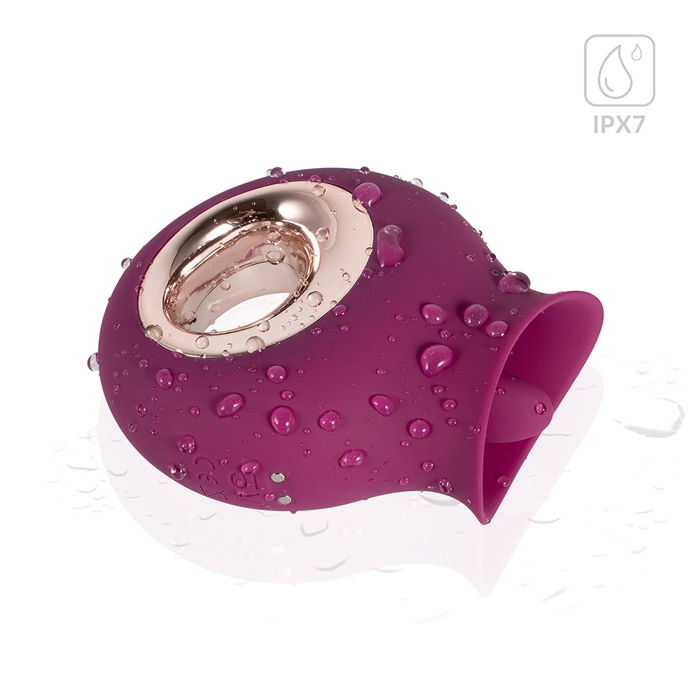 Honey Play Box Alvina Tongue Licking Vibrator Magenta with a glossy finish and water droplets for stimulation.