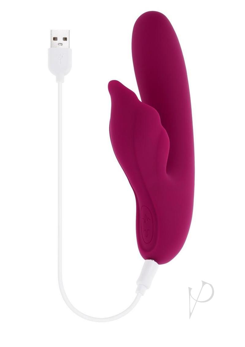 Evolved Venus Vibrator with Clitoral Stimulator Red charging with USB cable on a white background.