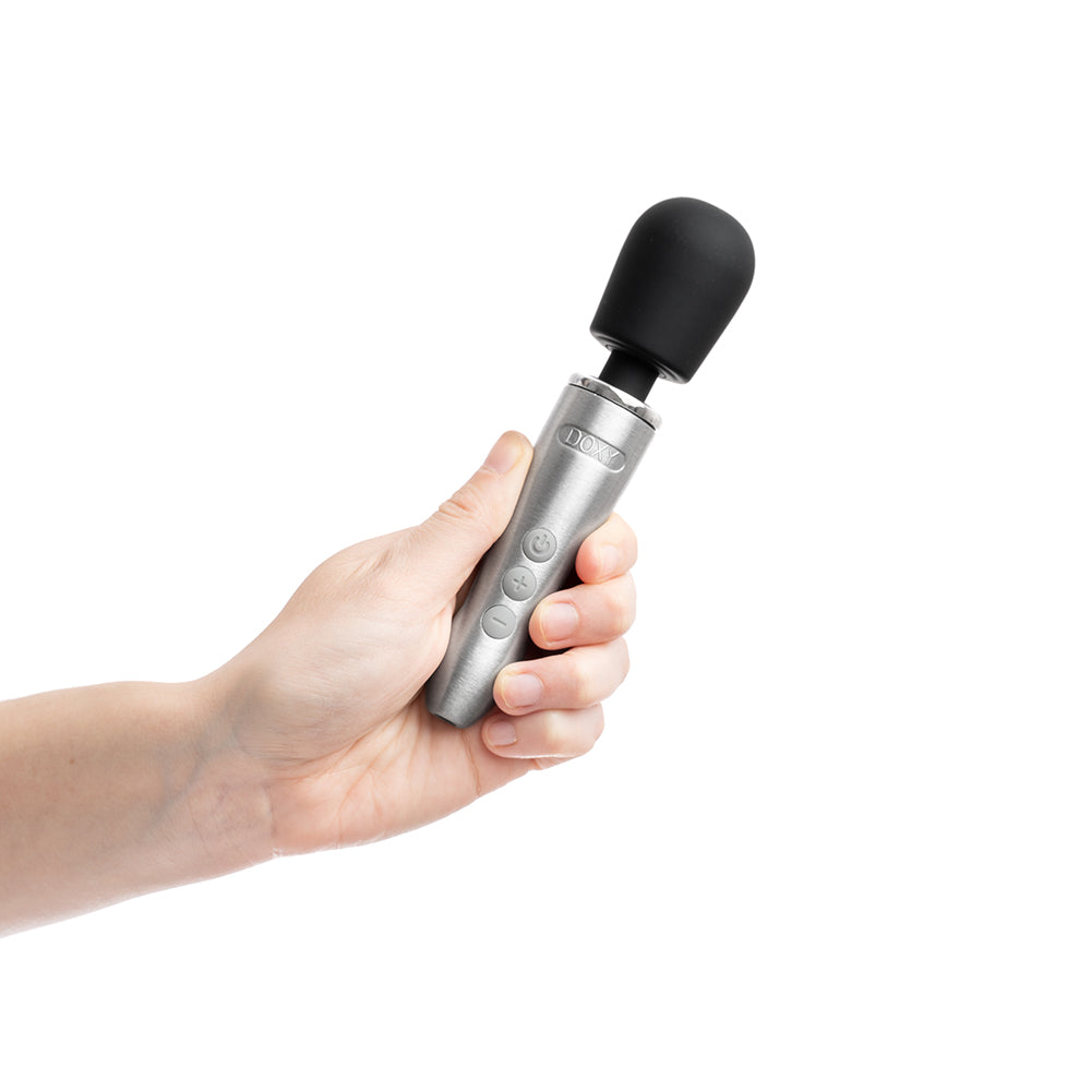 Doxy Go Travel-sized Wand Massager Silver held in hand, showcasing its sleek design and travel-friendly size.
