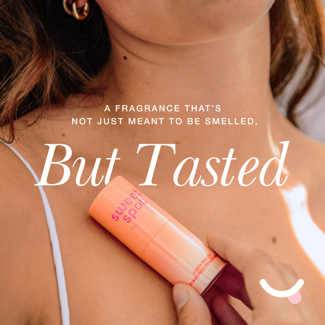 Sweetums Sweet Spot Flavored Fragrance Juicy Peach solid fragrance stick on skin with playful text overlay.