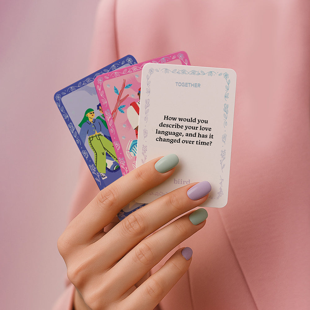 Biird X Jouissance Club Together Couples Card Game with colorful cards explored in a hand, enhancing connection.