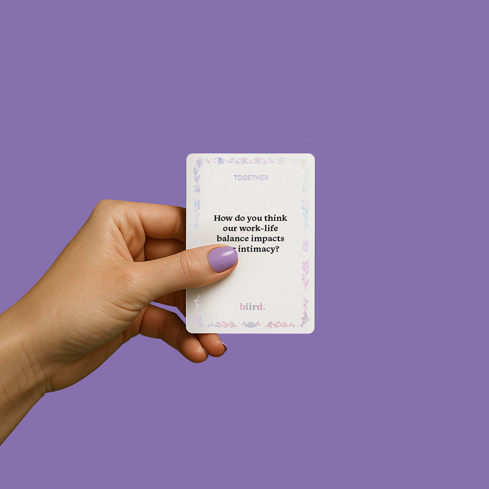 Hand holding Biird X Jouissance Club Together Couples Card Game card with a question about work-life balance and intimacy.