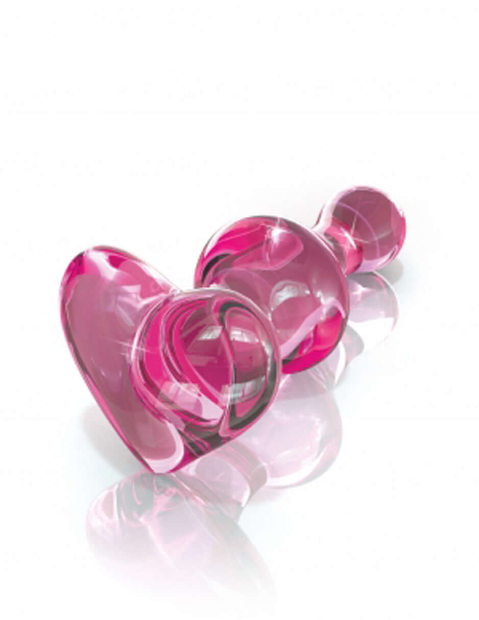 Icicles No 75 Glass Anal Plug Pink showcasing its elegant design and vibrant pink color on a reflective surface.
