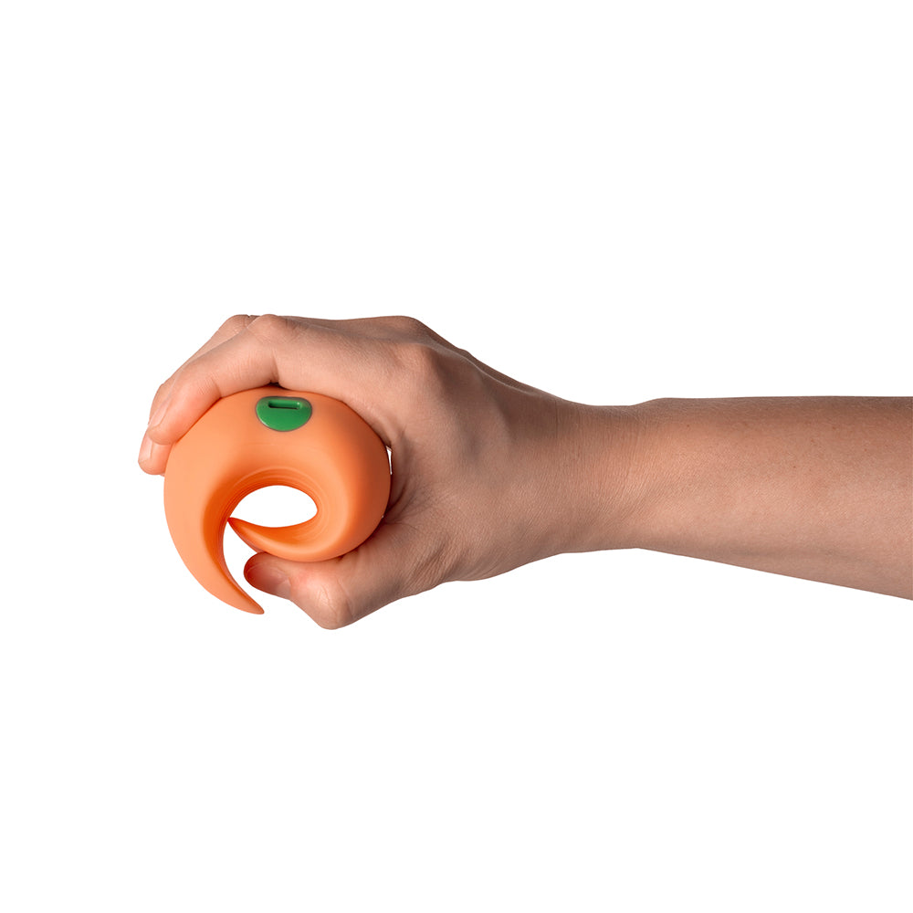 Hand holding the Emojibator Peach Vibrating Stroker, showcasing its compact design.
