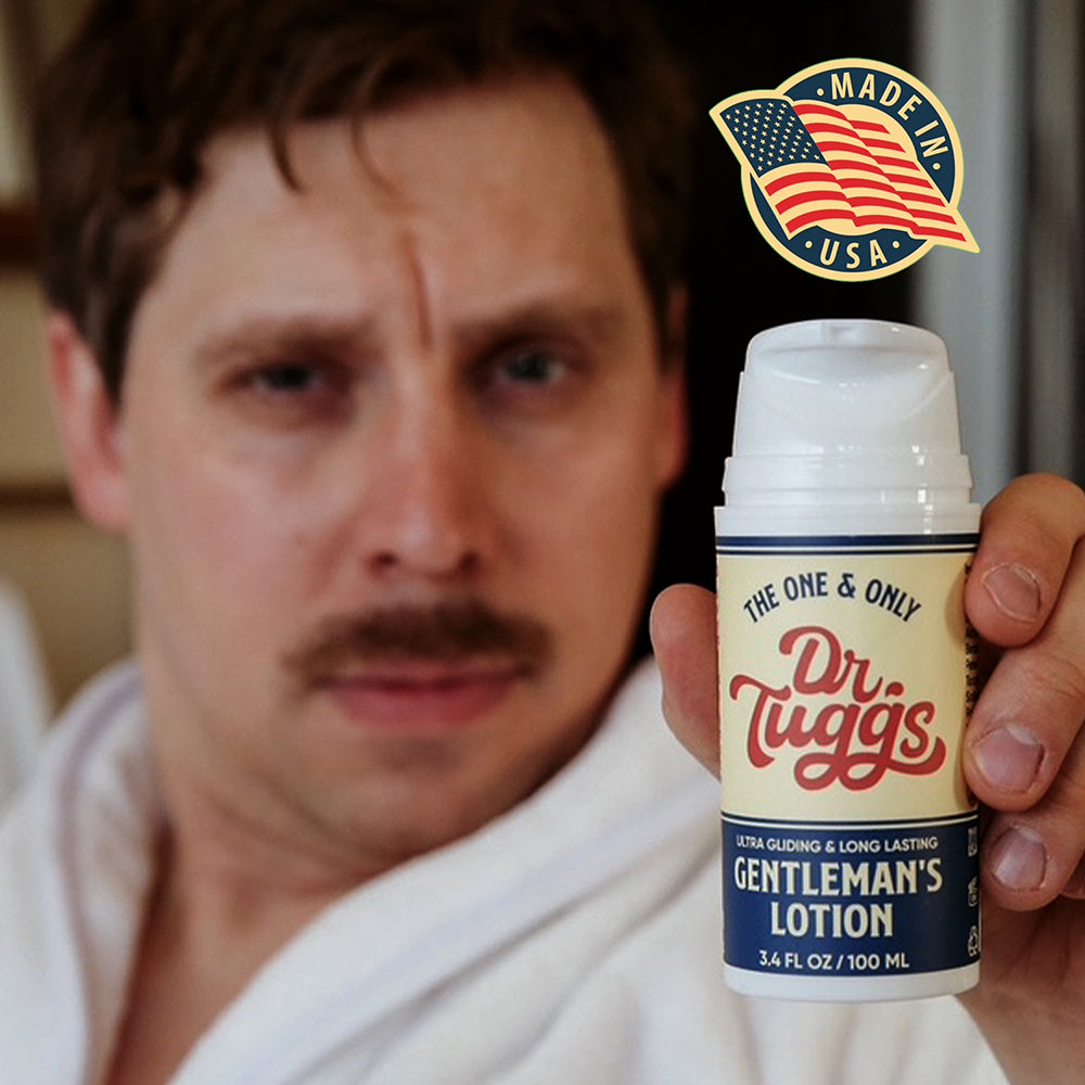 Dr Tuggs Gentleman's Masturbation Lotion 3.4 Oz held by a man in a bathrobe, featuring a Made in USA label.