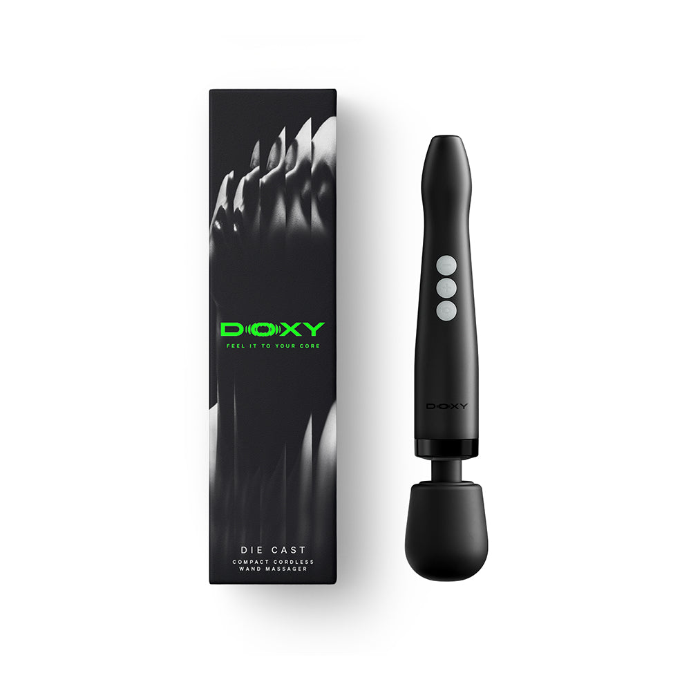 Doxy Die Cast Compact Cordless Wand Massager Black on display with packaging.