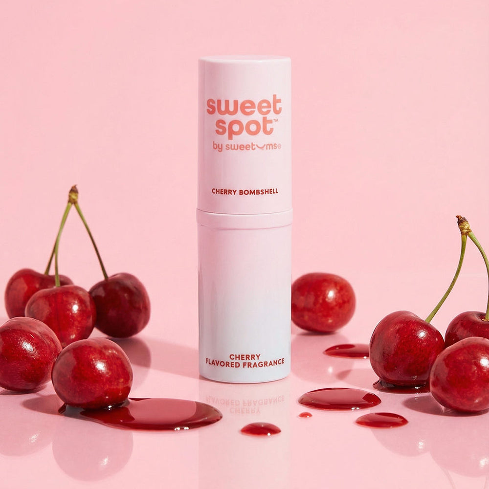 Sweetums Sweet Spot Flavored Fragrance Cherry Bombshell with cherries on a pink background