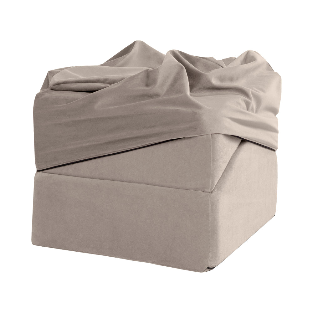 Liberator Flip Ramp Sex Positioning Pillow With Slip Cover Lush Cream folded and draped in soft fabric.