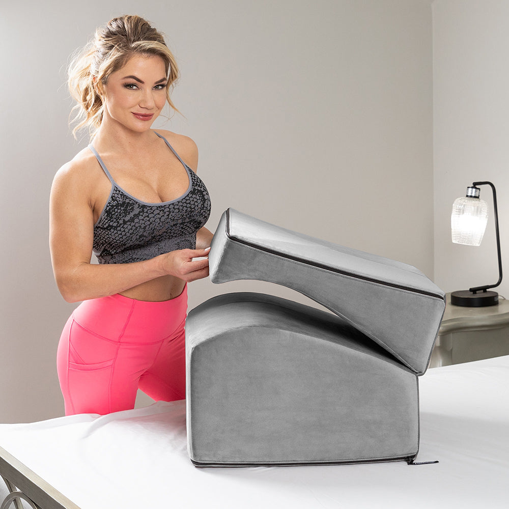 Liberator Flip Ramp Sex Positioning Pillow With Slip Cover Lush Grey being used in a modern bedroom setting.