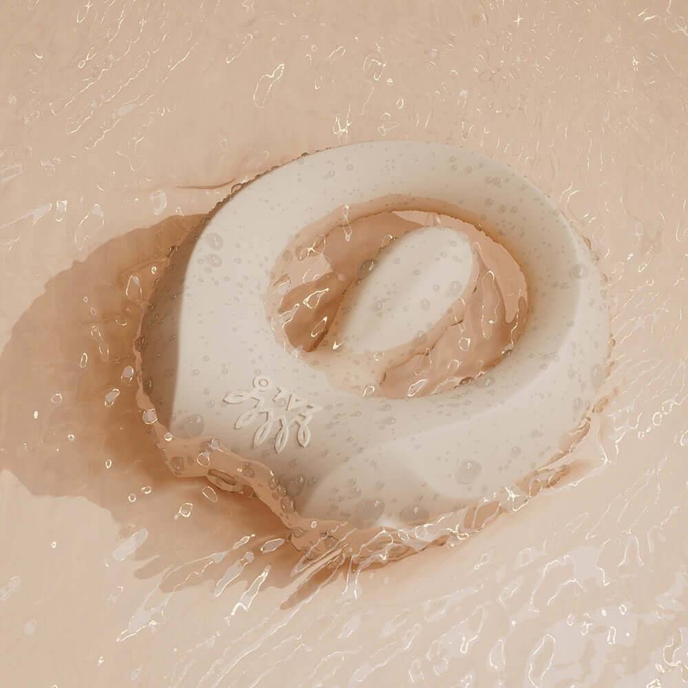 ZALO Apis Vibrating Couples Ring Ivory White floating in water showcasing its sleek design and premium silicone material.