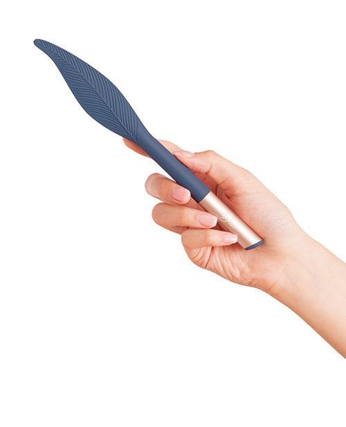 Deia Vibrating Feather Tickler with Charging Case Navy held in hand, showcasing its sleek design and soft silicone tip.