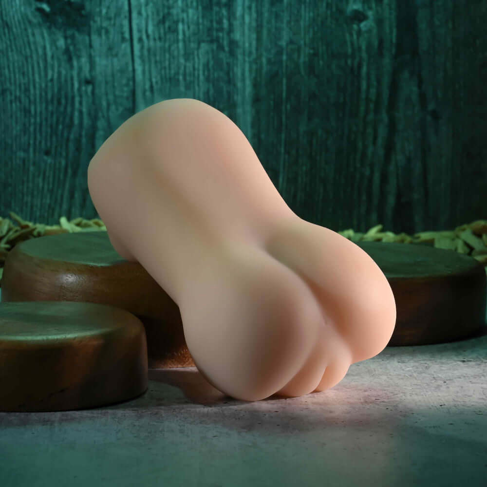 Sasha Grey Movie & Realistic Wet N Ready Stroker displayed on a textured surface, highlighting its design and shape.
